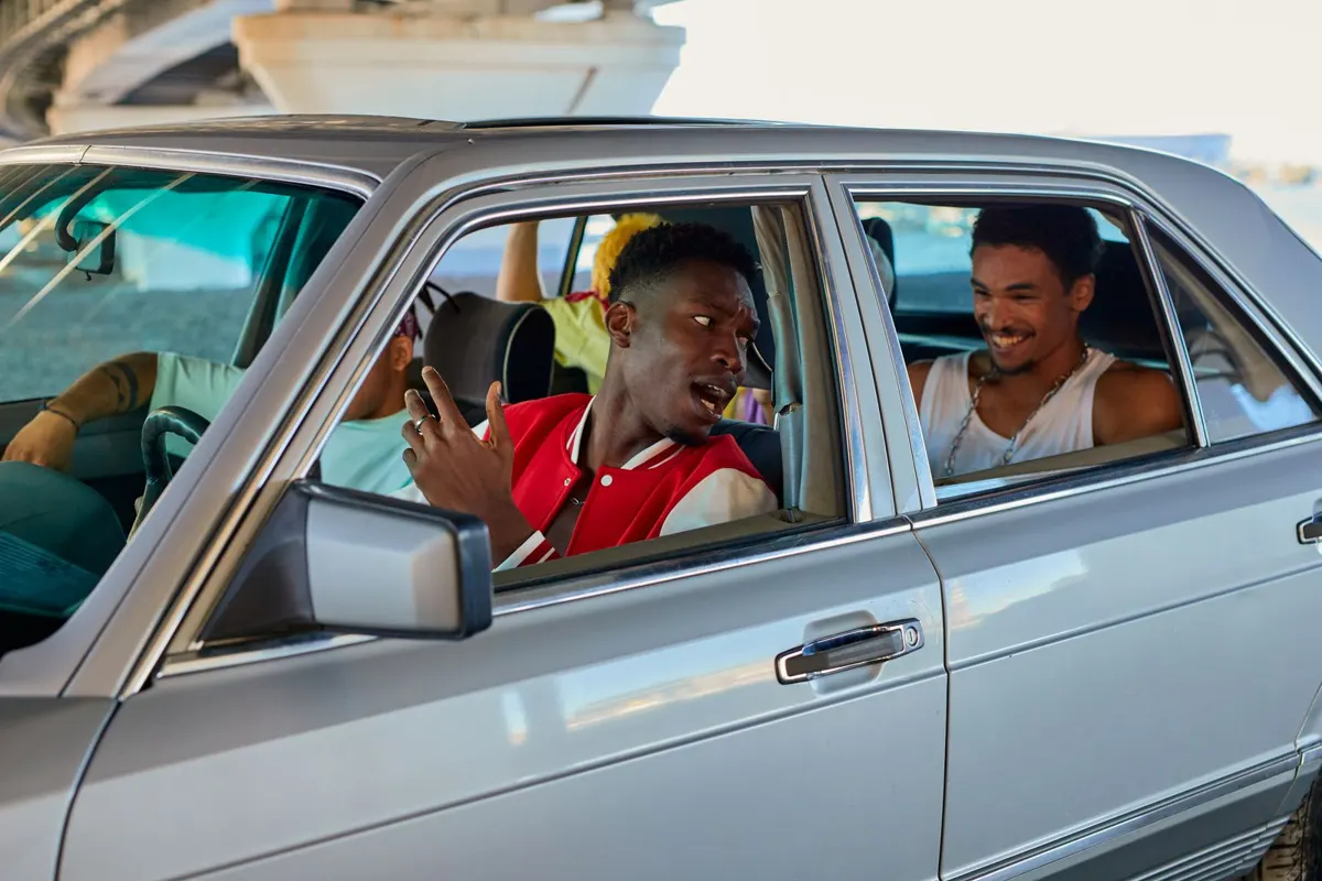 Friends chatting and laughing while sharing a ride in a sedan
